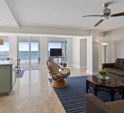 Relax in your open-plan living space where coastal blues meet modern comfort, and endless ocean views frame your perfect beach retreat.