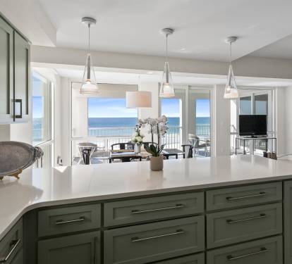 Cook with stunning ocean views from your modern kitchen, where pendant lights illuminate sleek counters and sea breezes flow through open doors.