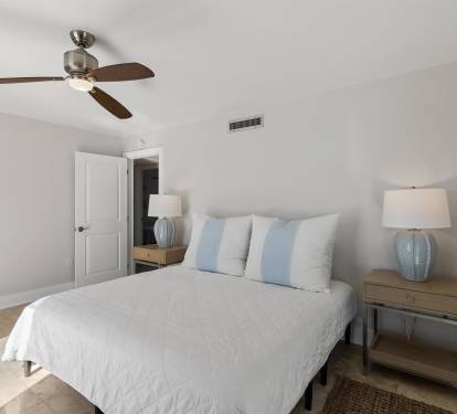 Your peaceful bedroom features soft coastal colors, crisp linens, and gentle ceiling fan breezes for restful nights.