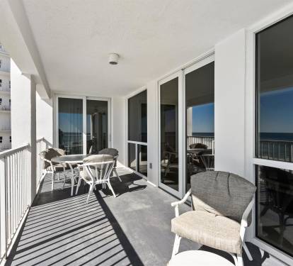 Relax on your private balcony with comfortable seating and stunning ocean views stretching to the horizon.