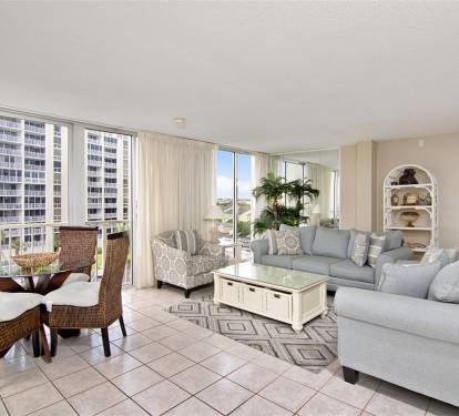 Your bright living space offers stunning city views through floor-to-ceiling windows, perfect for relaxing after exploring nearby attractions.
