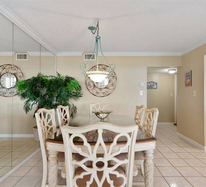 Gather around your elegant dining table for memorable meals, where decorative mirrors and warm lighting create the perfect atmosphere for every occasion.