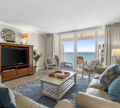 Sink into plush coastal furnishings while your private balcony frames endless ocean views through floor-to-ceiling windows.