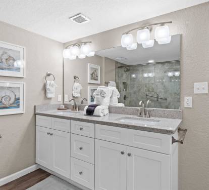 Your spacious bathroom features dual sinks, elegant granite countertops, and modern lighting to start your morning refreshed.