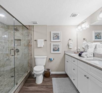 Your elegant bathroom features marble shower, granite counters, and coastal artwork creating a spa-like retreat.