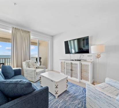 Relax in your bright living room with ocean views streaming through floor-to-ceiling windows. Sink into plush seating while enjoying coastal breezes from your private balcony.