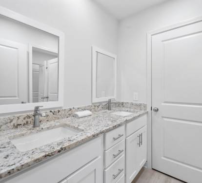Your pristine bathroom features elegant granite countertops and dual sinks, perfect for getting ready together.