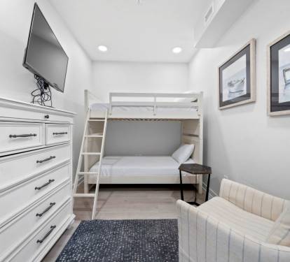 Your cozy bedroom features a space-saving bunk bed and comfortable seating area, perfect for relaxing after your adventures.