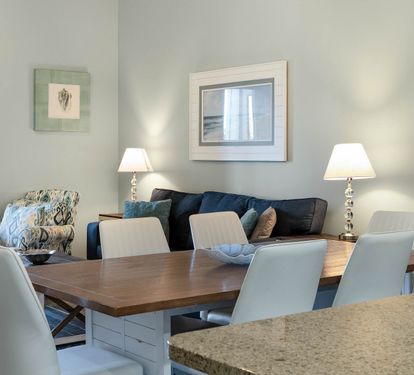 Gather around your elegant dining table for memorable meals, with comfortable seating and warm lighting creating the perfect atmosphere for your stay.