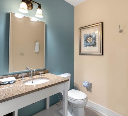 Fresh up in your coastal-themed bathroom with granite counters, elegant lighting, and soft towels waiting for you.