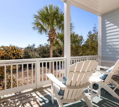 Relax in your private balcony chairs while enjoying tropical palm views and gentle morning light filtering through the covered porch.
