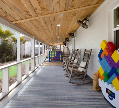 Settle into wooden rockers on your covered porch, where oversized games and warm lighting create perfect evenings for family fun.