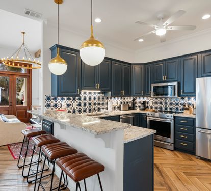 Your gourmet kitchen features navy cabinets, granite counters, and a breakfast bar where you'll savor morning coffee.