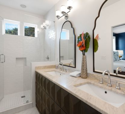 Indulge in your luxurious master bathroom featuring dual vanities, elegant marble countertops, and a spacious glass-enclosed shower for ultimate relaxation.