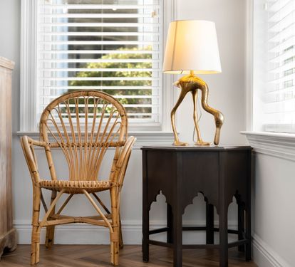 Settle into your cozy reading nook with a charming wicker chair and warm lamp, where afternoon light filters through plantation shutters.