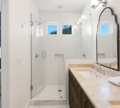 Your private ensuite bathroom features elegant marble counters, a spacious walk-in shower, and tropical touches for a spa-like experience.