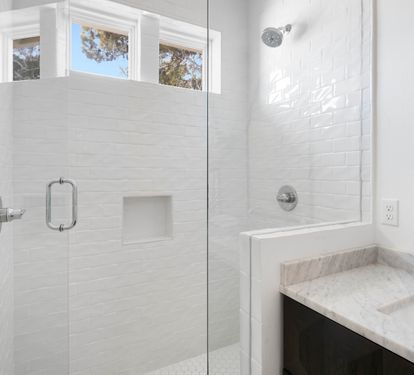 Bright, spa-like bathroom with walk-in shower and marble vanity awaits your daily refresh.