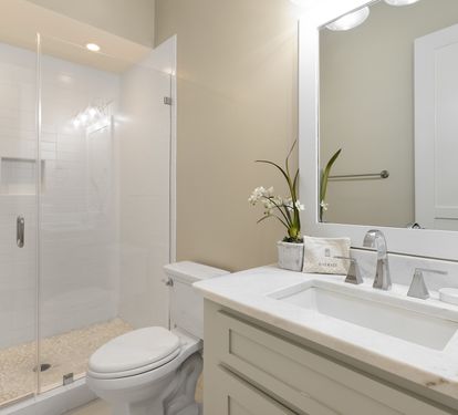 Step into your pristine bathroom where marble countertops and a spacious glass shower create a spa-like retreat for your daily rituals.