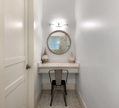 Your private vanity nook features elegant lighting and a cozy chair—perfect for morning routines or evening touch-ups.