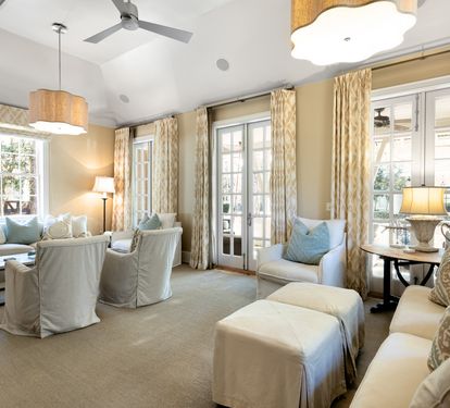 Sink into plush seating where elegant gold curtains frame natural light, creating your perfect retreat for relaxation and conversation.