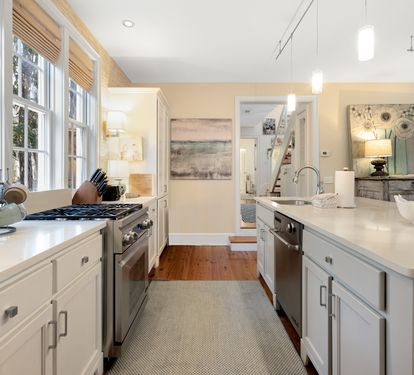 Cook with ease in this bright, open kitchen featuring modern appliances and pristine countertops flooded with natural light.