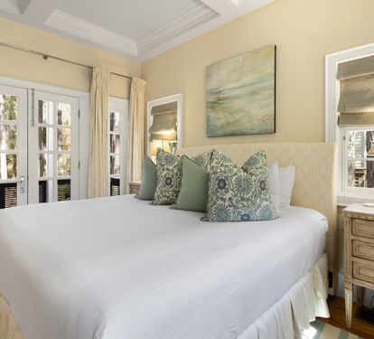 Sink into luxurious comfort with soft linens and elegant coastal touches creating your perfect retreat.