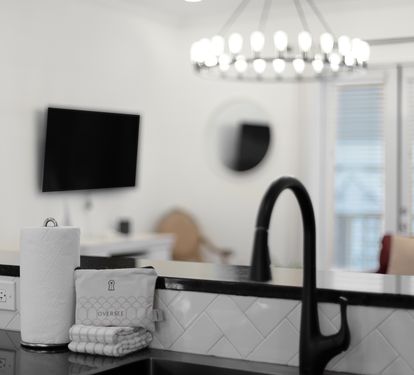 Enjoy your morning coffee in this bright, modern kitchen with sleek fixtures and stylish tile backsplash.