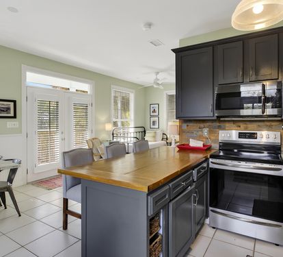 Cook memorable meals in your spacious kitchen with stainless appliances, wood countertops, and natural light streaming through French doors.