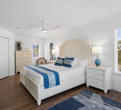 Sink into coastal comfort in your serene bedroom, where ocean-inspired blues meet crisp white linens for your perfect getaway retreat.