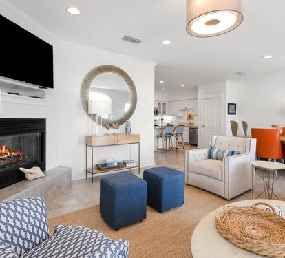 Unwind in your bright, modern living space with cozy fireplace, stylish furnishings, and open kitchen—perfect for relaxing evenings.