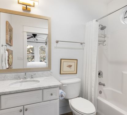 Your pristine bathroom awaits with marble countertops, plush towels, and a relaxing tub-shower combo perfect for unwinding after your adventures.