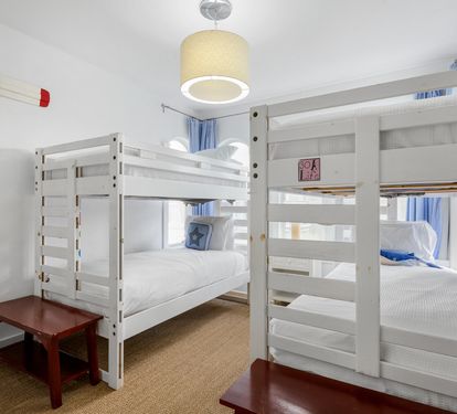 Cozy bunk room with fresh linens and nautical touches - perfect for kids or groups sharing adventures together.