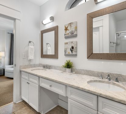 Refresh in your elegant ensuite with dual vanities, marble countertops, and coastal charm—perfectly connected to your peaceful bedroom retreat.