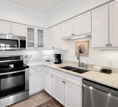 Your bright, fully-equipped kitchen awaits with granite counters, stainless appliances, and everything you need to prepare meals during your stay.