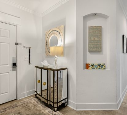 Step into your welcoming entry where coastal charm meets modern comfort, featuring thoughtful decor and bright, airy hallways.