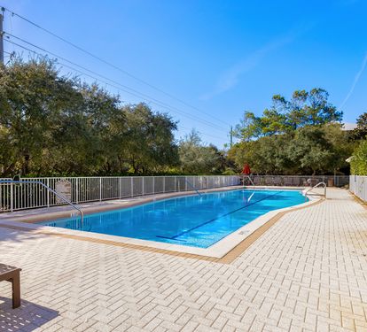 Sparkling pool surrounded by brick pavers creates your perfect spot for morning swims and sunny afternoon relaxation.