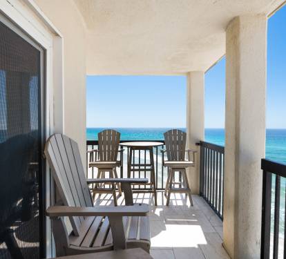 Your private balcony overlooks endless turquoise waters, where Adirondack chairs invite you to sip morning coffee while gulf waves create the perfect soundtrack.