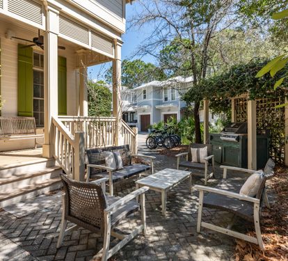 Relax in your private courtyard oasis with comfortable seating and lush greenery creating the perfect outdoor retreat.