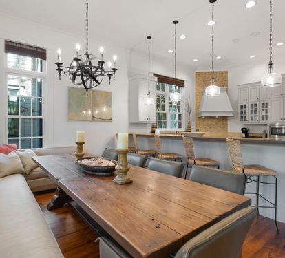 Gather around this rustic dining table while your chef creates magic in the open kitchen. Natural light streams through tall windows.