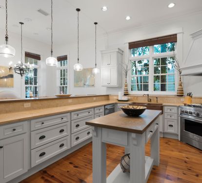 Your spacious kitchen invites culinary adventures with gleaming countertops, modern appliances, and warm natural light streaming through charming windows.