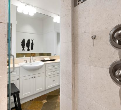 Step into your private spa-like shower with elegant marble walls and modern fixtures, creating the perfect space to refresh after your adventures.