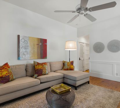 Relax in your stylish living room with cozy sectional seating, vibrant artwork, and thoughtful touches that make it feel like home.