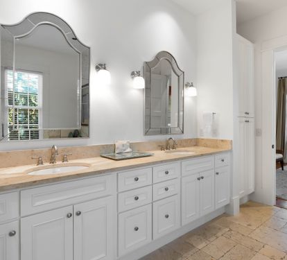 Luxurious master bathroom with dual vanities and elegant mirrors creates your perfect morning routine space.