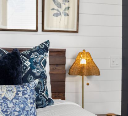 Sink into your comfortable bed adorned with beautiful blue patterned pillows and soft lighting that creates the perfect ambiance for relaxation.