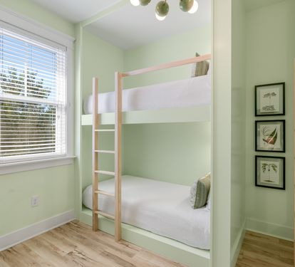 Your cozy bunk room features built-in beds with soft green walls, creating a peaceful retreat for restful nights.