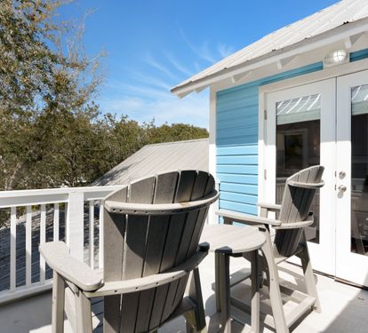 Step onto your private balcony where coastal breezes meet comfortable Adirondack chairs—perfect for morning coffee or evening relaxation.