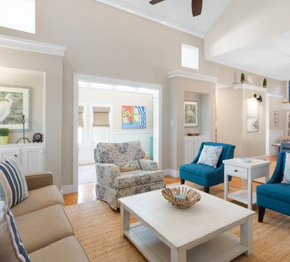 Sink into coastal comfort in your stylish living area, where teal accents and nautical touches create the perfect seaside retreat.