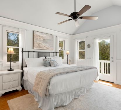 Drift into peaceful slumber in your airy bedroom with vaulted ceilings, gentle fan breeze, and French doors opening to your private balcony.