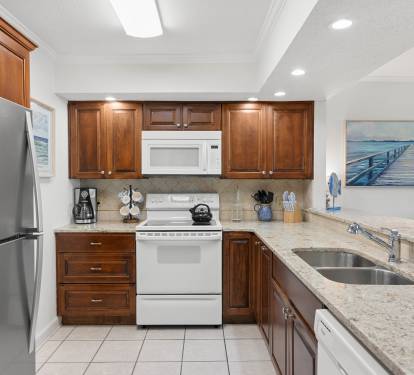 Your fully equipped kitchen features rich wood cabinetry, granite countertops, and modern stainless appliances for memorable meal preparation.