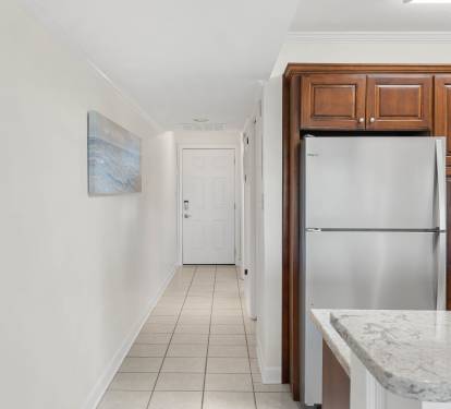 Your sleek kitchen features premium stainless steel appliances and rich wood cabinetry, with marble countertops perfect for meal prep.